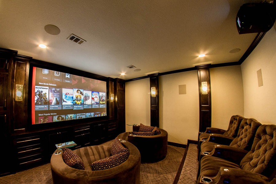A home theater with dark brown theater seating.