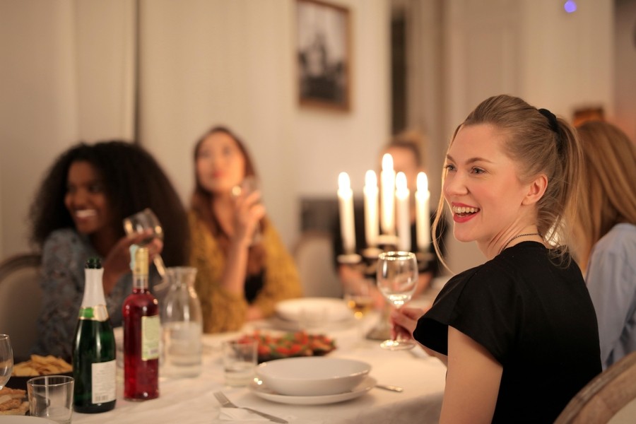 People sitting around a table enjoying a holiday dinner.