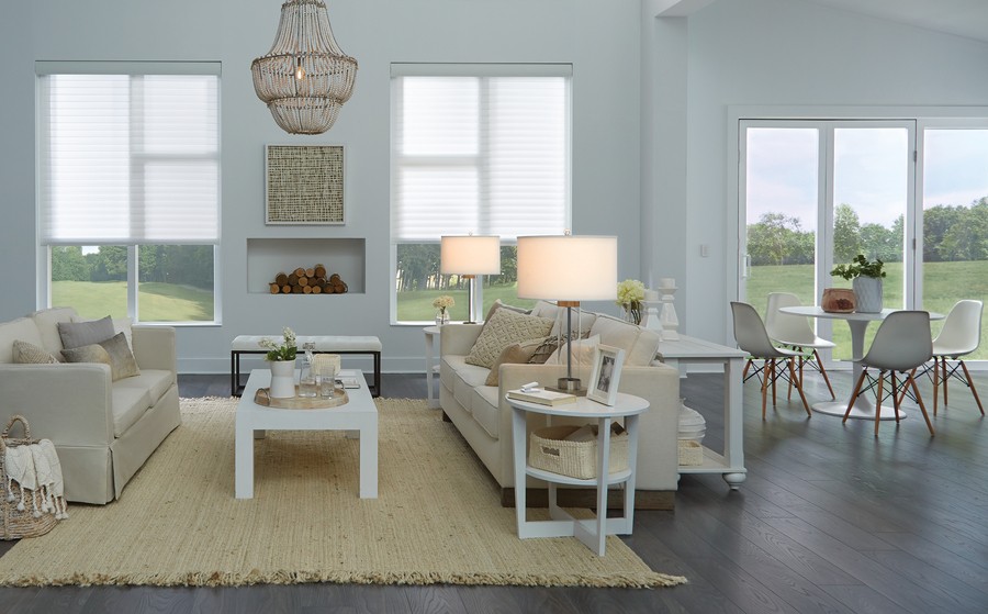 A home with a natural color scheme and design. Lutron shades are partially drawn over the windows.